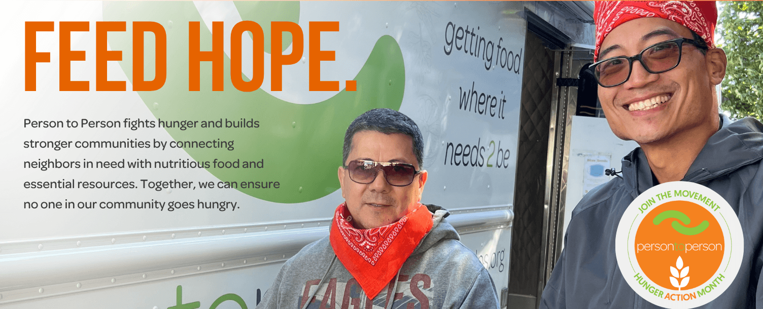 Volunteers serving hot meals at a food distribution event.